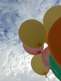Low angle view of balloons against sky
