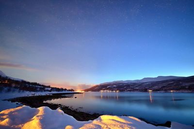 Scenic view of lake against sky at night