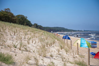 Scenic view of beach against blue sky