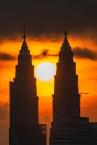 Silhouette of buildings against sky during sunset