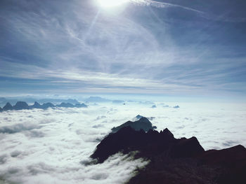 Scenic view of fog covered mountains against sky