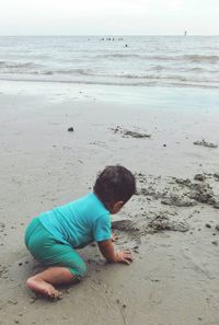 Rear view of boy on beach
