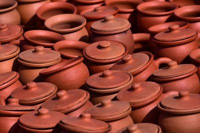 Full frame shot of earthenware bowls with lids stack