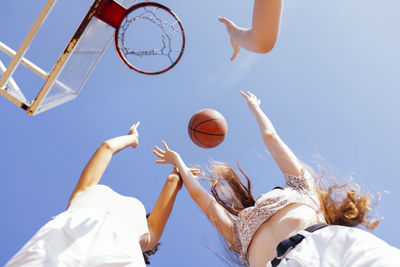 Low angle view of woman playing basketball