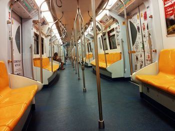 Yellow seats and metallic rods in train