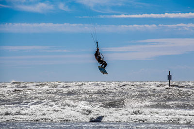 Man doing kiteboarding against sky