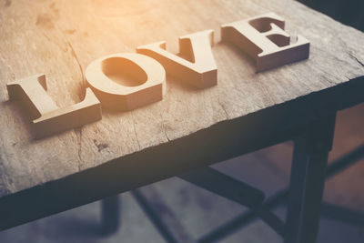 High angle view of love text on wooden table