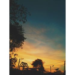 Low angle view of silhouette trees against sky during sunset