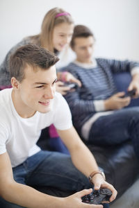 Children on sofa playing video game