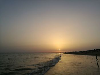 Scenic view of sea against clear sky during sunset