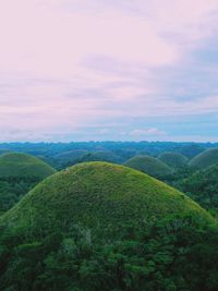 Scenic view of green landscape against sky