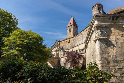 Historic castle complex veste coburg with green trees in the foreground