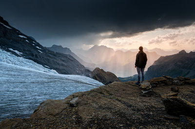 Full length of man standing on rock against sky