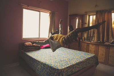 Woman relaxing on bed at home