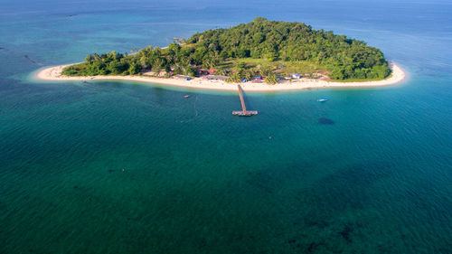 Aerial view of tropical rusukan besar island with wooden jetty and sandy beach in labuan ftmalaysia.