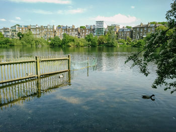 View of lake in city against sky