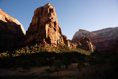 Rock formations on landscape against sky