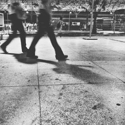 Shadow of woman on footpath