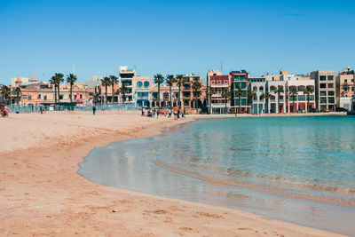 Scenic view of beach against clear blue sky