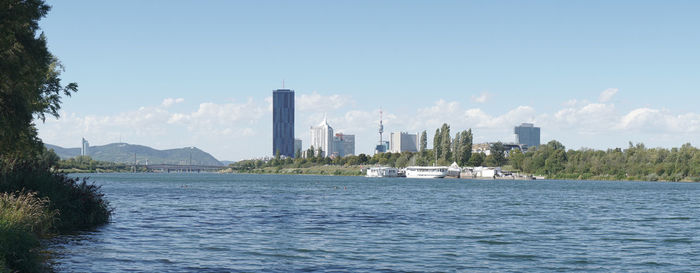 Scenic view of sea and buildings against sky