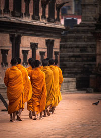 Rear view of people walking on street