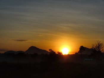 Scenic view of silhouette mountains against sky at sunset