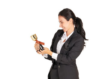 Young woman holding umbrella against white background