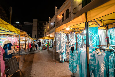 People at market stall at night