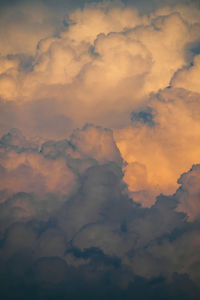 Flying drone in fluffy clouds in the sunlight. sunset with clouds