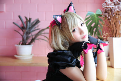 Portrait of young woman in costume sitting at cafe