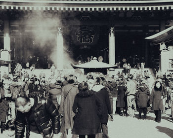 Rear view of people on street in city