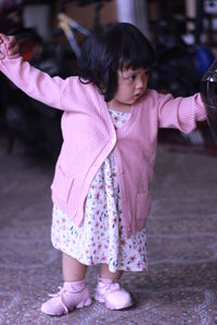 Cute girl standing with pink petals