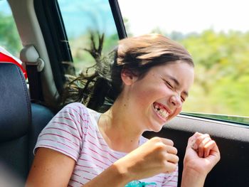 Close-up of girl sitting in car