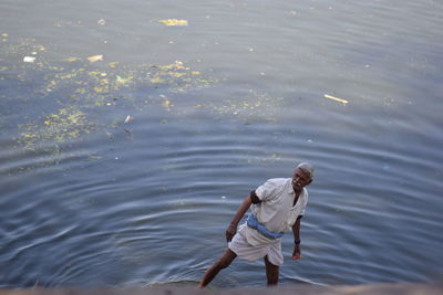 High angle view of man standing in sea