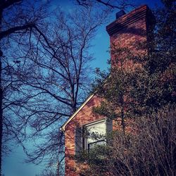 Low angle view of abandoned house against sky