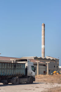 Factory against clear blue sky