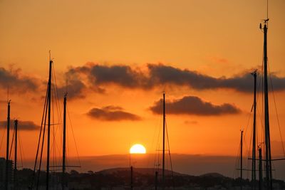 Silhouette sailboat against sky during sunset