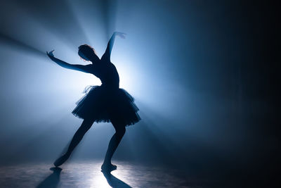 Silhouette ballet dancer dancing on stage