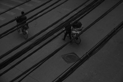 High angle view of people riding bicycle on street