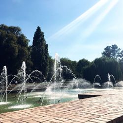 Fountain in park against sky