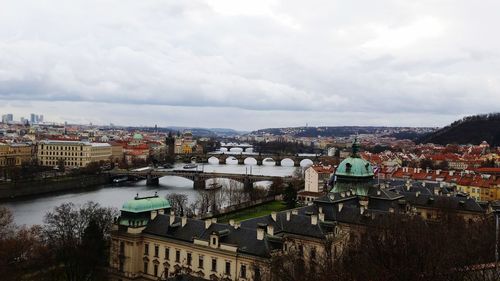 High angle view of river by buildings against sky