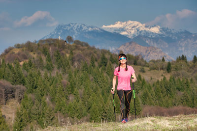 Full length of woman standing on mountain road against sky