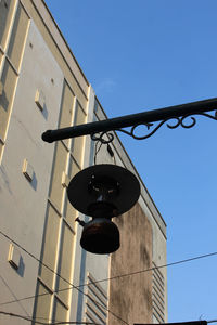 Low angle view of street light against building