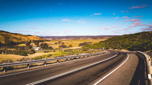 Road by mountain against sky