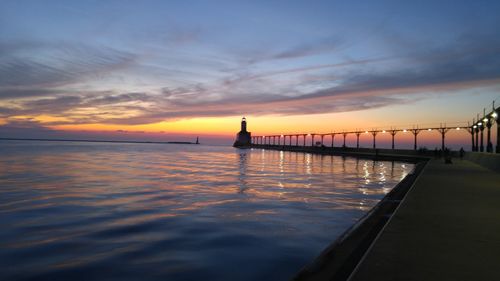 Pier on sea at sunset