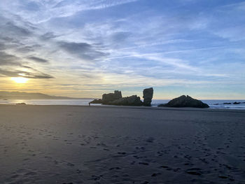 Scenic view of beach against sky during sunset