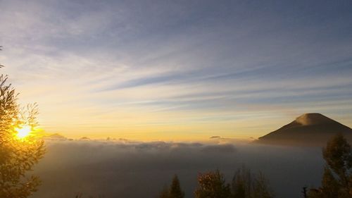 Scenic view of mountains against sky at sunset