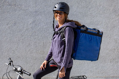 Woman riding bicycle delivering order