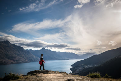 Full length of man standing on landscape against mountains