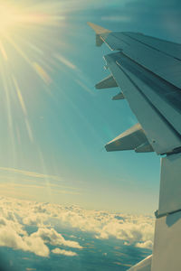 Aerial view of aircraft wing against sky during sunset